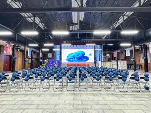 a large room with blue chairs and a screen at Chyanmu Hidden Village Retreat Near The Grand Canyon of Zhangjiajie and Yellow Dragon Cave With Local Culture Village Life Breakfast Quiet Wellness Escape for Urban Travelers Seeking Privacy and Peace in Zhangjiajie +76 photos