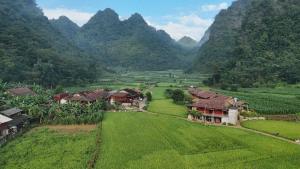 an aerial view of a village in a valley with mountains at Kim in Thổng Khào