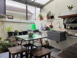 a kitchen with a table and chairs and plants at The Valley Guesthouse in Malang