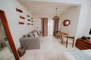 a living room with a couch and a table at Villa Marena Hotel Boutique in Coyuca