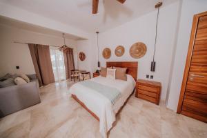 a large bedroom with a bed and a couch at Villa Marena Hotel Boutique in Coyuca