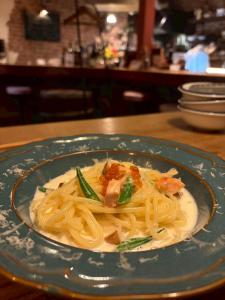 a plate of pasta with shrimp on a table at 夕食ご用意可能guesthouse Yokomachi 街の中心部 静かな通りの一棟貸切 in Shingū +18 photos