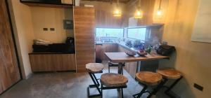 a kitchen with a bar with stools and a counter at Villa colibrí in Piñas +22 photos