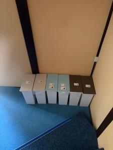 a row of boxes sitting on a shelf in a room at GATE80香住 無人宿 完全セルフ 予約メッセージ欄確認要す スマートロック 暗証番号チェックイン 素泊まり専門 アメニティ持参で格安滞在 セコム24h監視 駐車場10台 in Kami