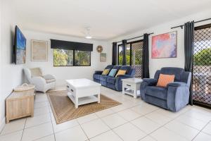 a living room with couches and a table at A Lure - 100m to Main Beach in Agnes Water