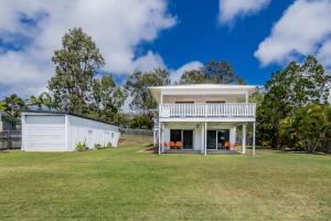 a white house with a large yard at A Lure - 100m to Main Beach in Agnes Water