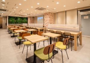 a classroom with tables and chairs in a cafeteria at Super Hotel Sendai Hirose Dori in Sendai