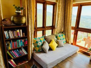 a living room with a couch and a book shelf at The Sayo Ratnari in Bāgi