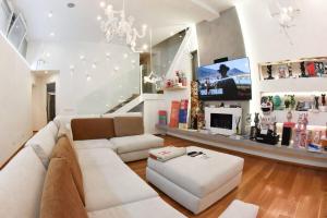 a living room with a couch and a tv at Milan Luxury Loft with Sauna & Jacuzzi in Milan