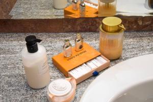 a bathroom counter with soap and other items on it at Milan Luxury Loft with Sauna & Jacuzzi in Milan +34 photos