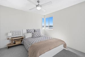 a bedroom with a bed and a ceiling fan at Seascape U7 in Golden Beach