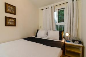 Habitación pequeña con cama y ventana en Orna's Corner en Yuval