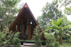 a small tree house in the middle of a garden at Hidden Gem Elephant in Chiang Mai