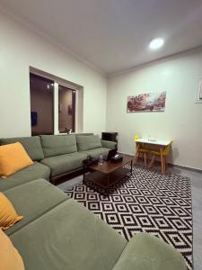 a living room with a couch and a table at أوريانا oRIANA in Jeddah