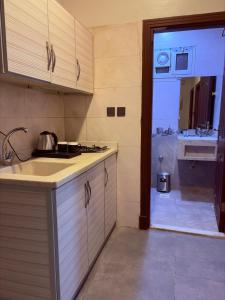 a kitchen with a sink and a counter top at أوريانا oRIANA in Jeddah
