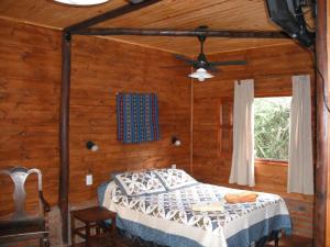 a bedroom with a bed and a ceiling fan at Cabañas El Paraiso in San Salvador de Jujuy +44 photos
