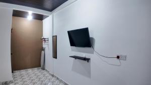 a room with a flat screen tv on a wall at F&D Homestay in Semporna +14 photos