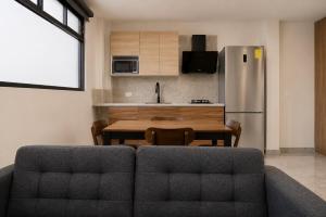 a kitchen and dining room with a table and a refrigerator at Loft Ejecutivo San Martin Centro Wifi Tv 65 in San Martín Texmelucan de Labastida