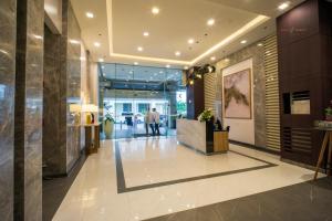 a lobby of a building with people walking in it at Voice activated studio condo unit at One Regis Megaworld, JK Modern Nest in Bacolod +46 photos