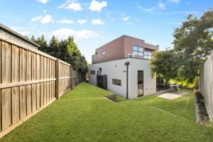 a backyard view of a house with a fence at Sleek Contemporary Haven Geelong in Highton