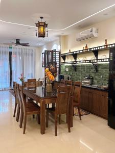 a dining room and kitchen with a table and chairs at HueS Home in Hue