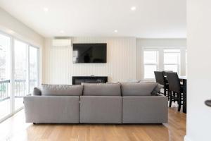 a living room with a couch and a dining room at Beautiful and Spacious 3BD Condo in Somerville in Somerville