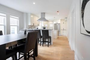 a kitchen and dining room with a table and chairs at Beautiful and Spacious 3BD Condo in Somerville in Somerville