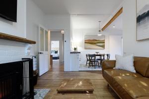 a living room with a couch and a table at Garden Cottage, Wellness Studio & Bike Shed in Winnaleah