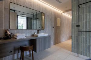 a bathroom with a sink and a mirror at 晴井villa in Huxi +68 photos
