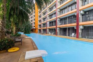 a large swimming pool in front of a building at Beachside 1BR Condo Pool Gym Phuket- MBC C172 in Ban Bo Sai Klang