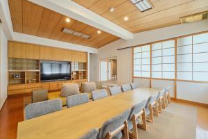 a conference room with a large table and chairs at Yunokawa Kagura in Hakodate