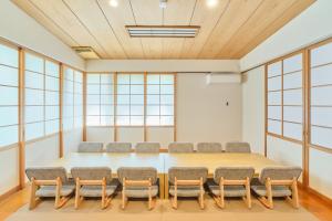 a conference room with a large table and chairs at Yunokawa Kagura in Hakodate