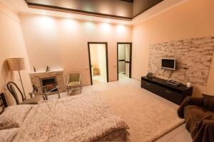 a bedroom with a bed and a tv and a fireplace at Studio Ember at Maidan Konstytutsii in Kharkiv