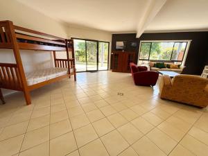 a living room with a bunk bed and a couch at Jaspa - River Views - Bring your own linen in South West Rocks