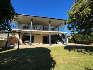 a building with a balcony on the side of it at Jaspa - River Views - Bring your own linen in South West Rocks