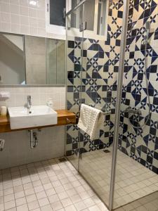 a bathroom with a sink and a shower at DayBreak 2 in Taitung City