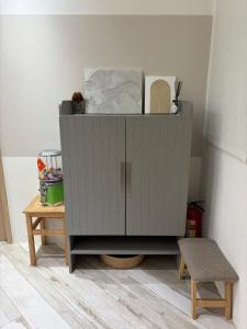 a gray cabinet in a room with a stool at DayBreak 2 in Taitung City +17 photos