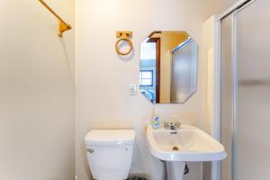a bathroom with a white toilet and a sink at Ski Bowl Cottage! in Hunter +13 photos