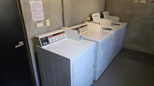 a row of washers and dryers in a room at Hotel R14 in Kaohsiung +32 photos