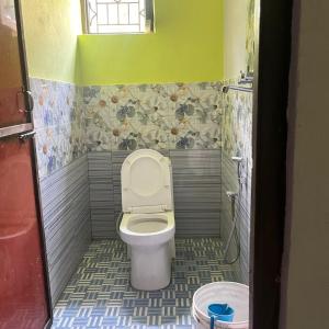 a bathroom with a toilet in a small room at Briddhim Guest House in Syābru Bensi