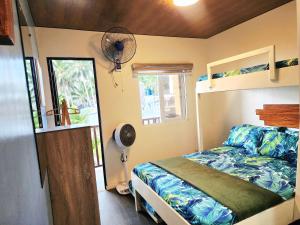 a bedroom with a bed in a tiny house at Puffer Isle Resort in Dingalan +43 photos