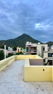 a balcony with a view of a mountain at JM Arunachala Stays in Tiruvannāmalai