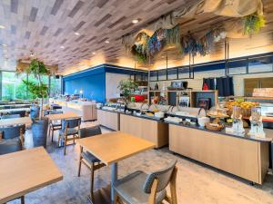 a restaurant with tables and chairs and a cafeteria at KKR Hotel Hakata in Fukuoka