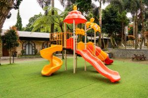 a playground with a slide in a park at Nimo Resort Ciater in Ciater