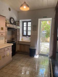a kitchen with a door open to a yard at Mytilini Townhouse in Mytilene +38 photos