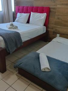 a bedroom with a bed with a towel on the floor at Flat 10 andar Hotel Caesar Towers acesso direto praia in Recife