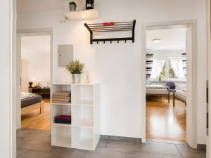 a living room with a white book shelf at Ferienwohnung Bailey in Laupheim