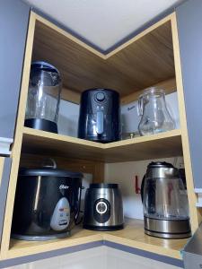 a kitchen shelf with various appliances on it at Refugio Nordico de 3 habitaciones inc Cochera en 2do piso in Trujillo