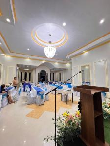 a conference room with tables and chairs and a podium at T'zam Villa in Dipolog +26 photos