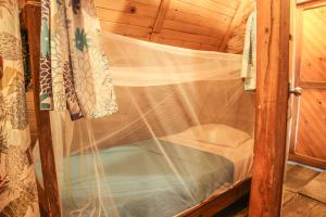 a small room with a window with a net at El Bosque Minca in Minca +91 photos